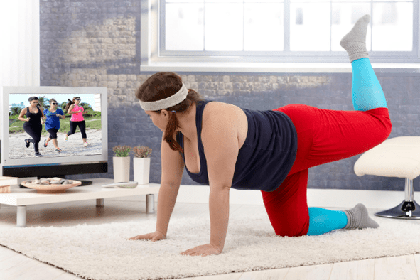 Overweight woman doing exercises to lose weight at home